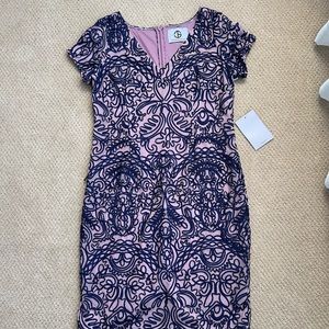 Embroidery dress with blue piping pattern.